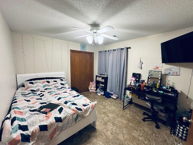 tiled bedroom with a textured ceiling, a closet, and ceiling fan