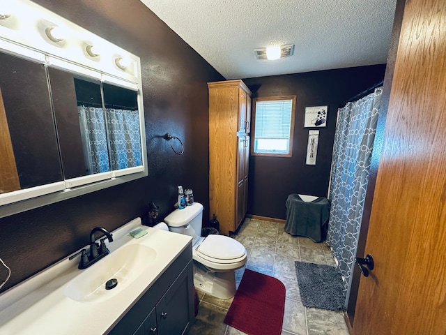 full bath featuring vanity, toilet, a textured wall, a textured ceiling, and visible vents
