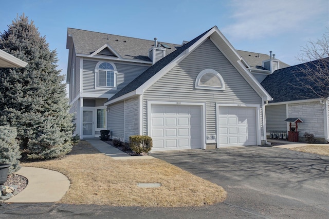 view of front of house with a garage and aphalt driveway