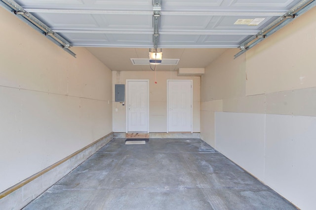 garage featuring electric panel and a garage door opener