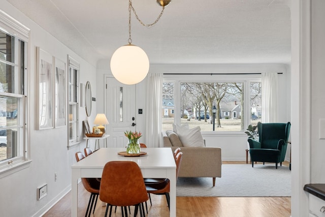 dining room featuring wood finished floors and baseboards