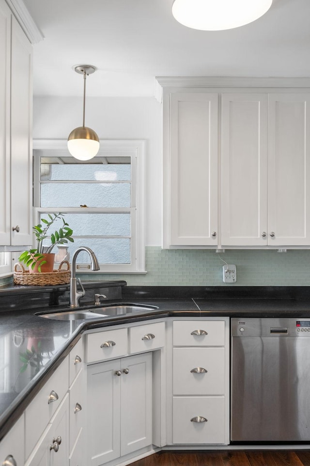 kitchen with a sink, backsplash, white cabinets, dishwasher, and hanging light fixtures