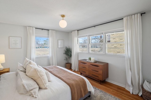 bedroom with wood finished floors and baseboards