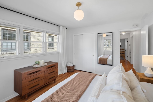 bedroom with wood finished floors and baseboards