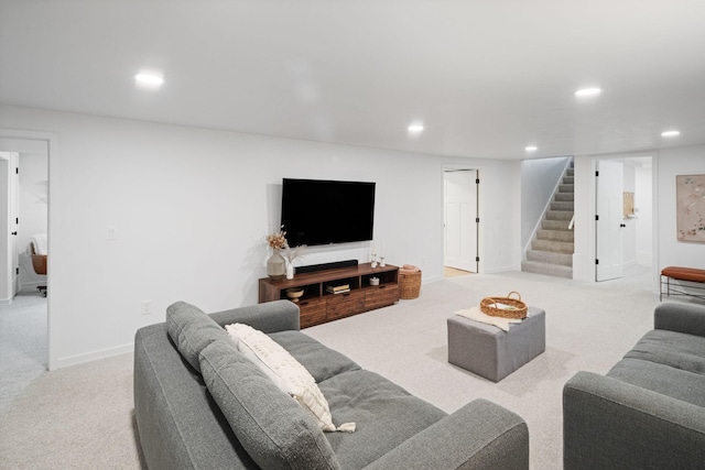 carpeted living area with recessed lighting, stairs, and baseboards