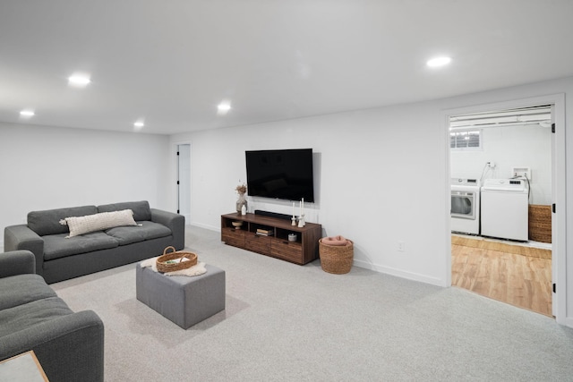 carpeted living room with recessed lighting, baseboards, and washer and clothes dryer