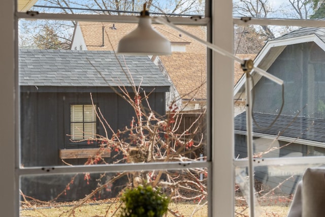 view of side of home with a shingled roof