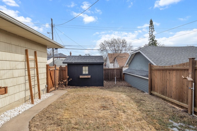 view of yard with a shed, an outdoor structure, and a fenced backyard