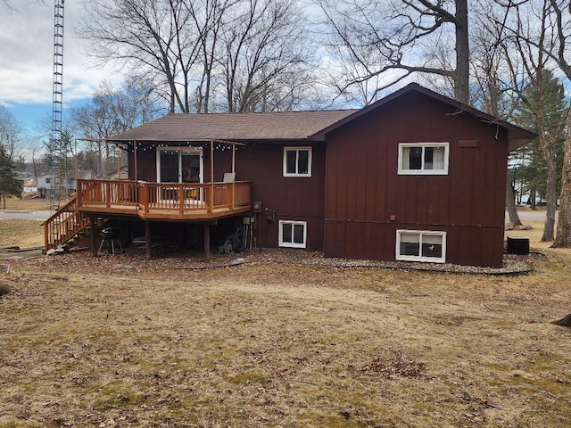 rear view of property with stairs and a wooden deck