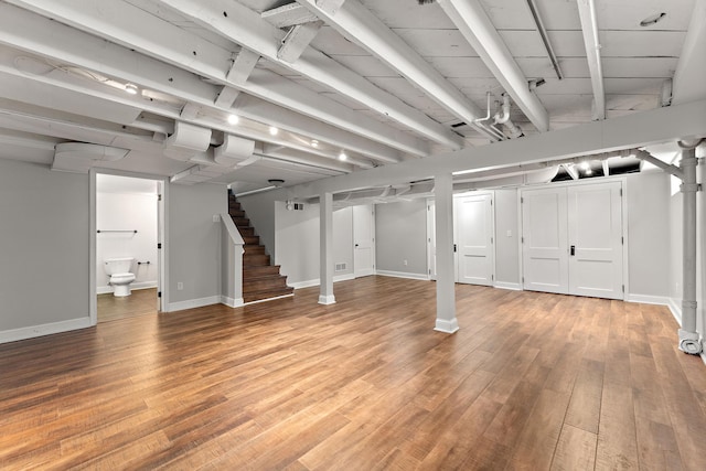 910 Nevada Ave W, Saint Paul, MN 55117 - finished below grade area with stairway, baseboards, and light wood finished floors