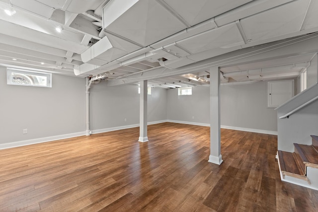 910 Nevada Ave W, Saint Paul, MN 55117 - below grade area with stairway, wood finished floors, and baseboards