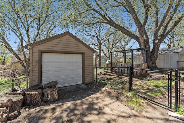 910 Nevada Ave W, Saint Paul, MN 55117 - detached garage featuring driveway, fence, and a gate
