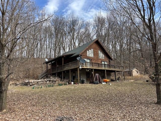 rear view of house featuring a wooden deck