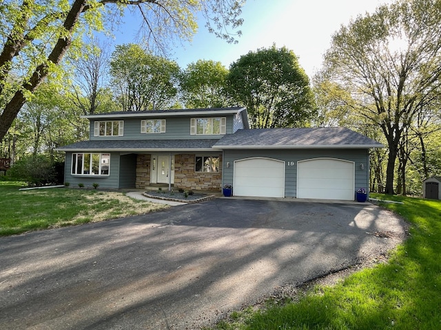 19 Robin Ct, North Mankato, MN 56003 - traditional-style house with an attached garage, driveway, a front yard, and stone siding