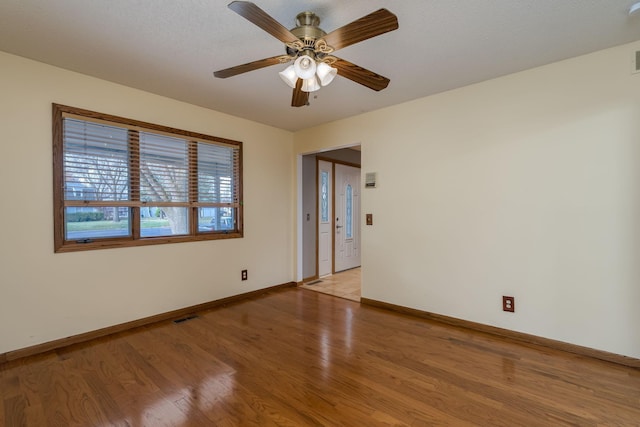 19 Robin Ct, North Mankato, MN 56003 - spare room featuring light wood-style flooring, baseboards, and a ceiling fan