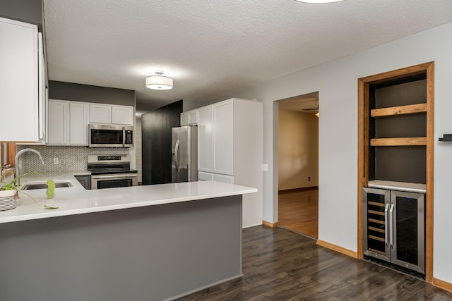 19 Robin Ct, North Mankato, MN 56003 - kitchen with stainless steel appliances, beverage cooler, a sink, dark wood-style floors, and light countertops