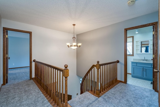 19 Robin Ct, North Mankato, MN 56003 - stairway featuring carpet, a chandelier, and baseboards