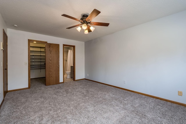 19 Robin Ct, North Mankato, MN 56003 - unfurnished bedroom featuring a walk in closet, carpet flooring, baseboards, ensuite bath, and a closet