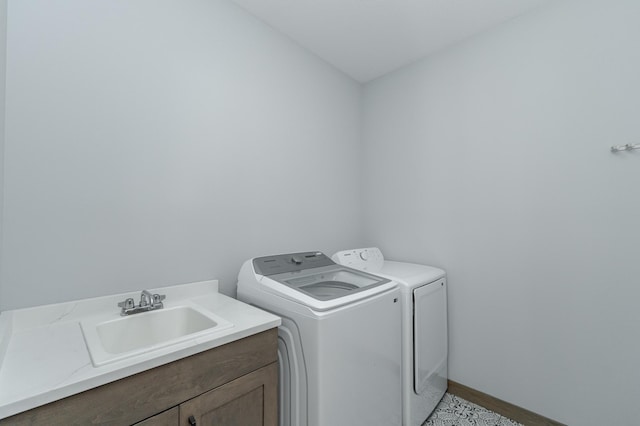 laundry room featuring washer and clothes dryer, baseboards, and cabinet space