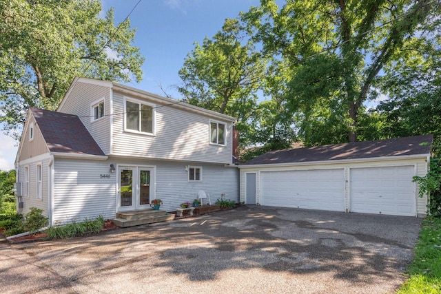 5446 Bartlett Blvd, Mound, MN 55364 - colonial-style house featuring a detached garage, an outbuilding, and roof with shingles
