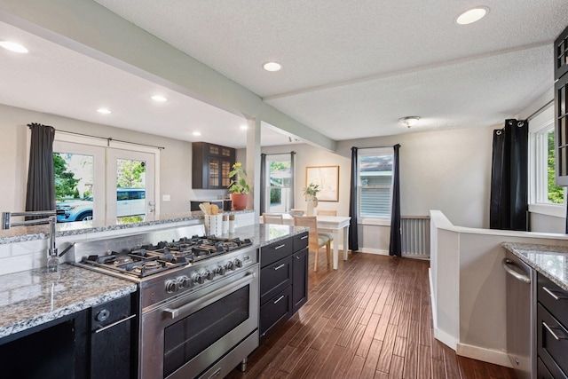 5446 Bartlett Blvd, Mound, MN 55364 - kitchen featuring stainless steel stove, dark cabinets, dark wood-style floors, recessed lighting, and light stone countertops