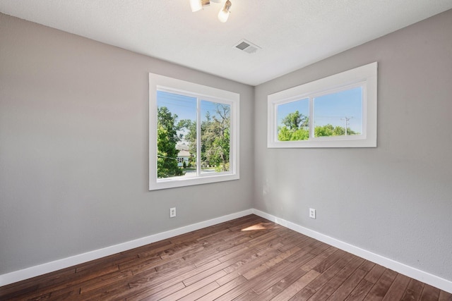 5446 Bartlett Blvd, Mound, MN 55364 - spare room featuring dark wood-style flooring and baseboards