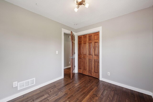 5446 Bartlett Blvd, Mound, MN 55364 - unfurnished bedroom featuring dark wood-type flooring and a closet