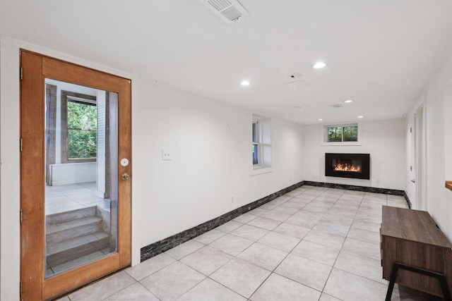 5446 Bartlett Blvd, Mound, MN 55364 - unfurnished living room featuring a lit fireplace, recessed lighting, plenty of natural light, and light tile patterned floors