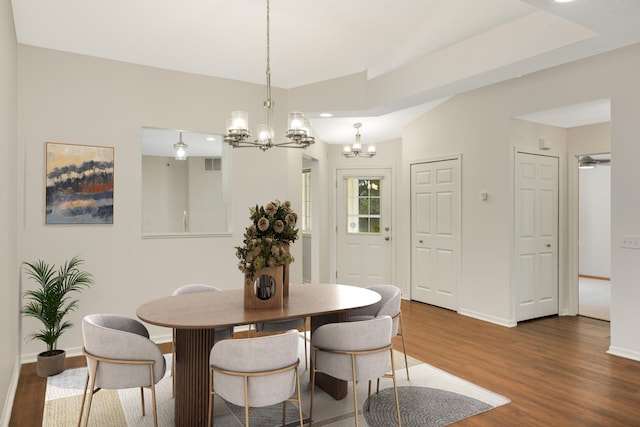 dining room with a chandelier, wood finished floors, and baseboards