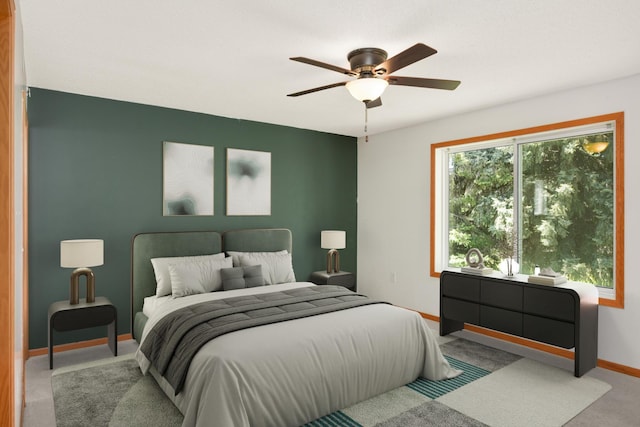 carpeted bedroom featuring baseboards and a ceiling fan