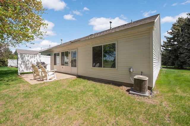 rear view of house featuring a patio, cooling unit, and a lawn