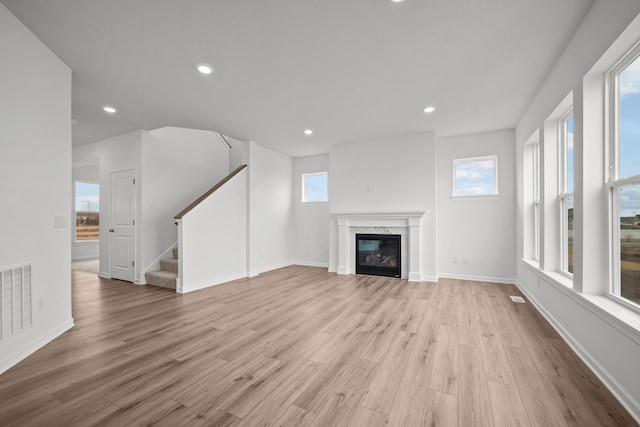 1520 Philipp Way, Shakopee, MN 55379 - unfurnished living room featuring wood finished floors, a premium fireplace, stairway, recessed lighting, and baseboards