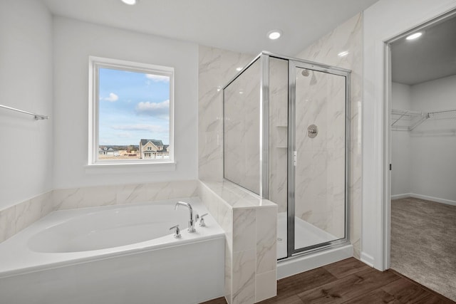 1520 Philipp Way, Shakopee, MN 55379 - bathroom with a garden tub, a marble finish shower, a walk in closet, recessed lighting, and wood finished floors
