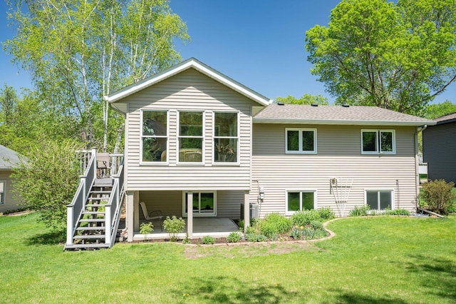 1944 Linda Ln, Saint Cloud, MN 56301 - back of property with a lawn, stairs, a wooden deck, and a patio