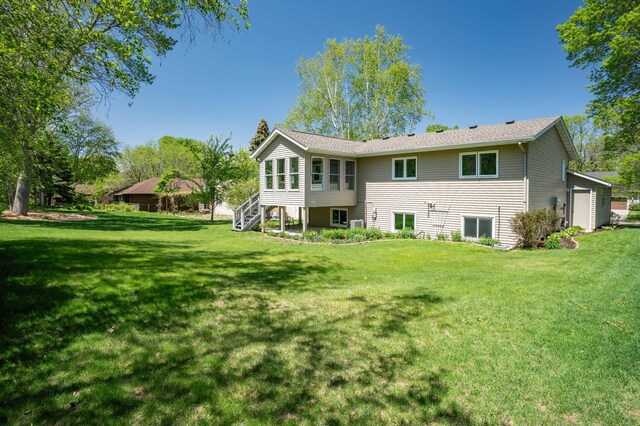 1944 Linda Ln, Saint Cloud, MN 56301 - rear view of house featuring stairway and a lawn