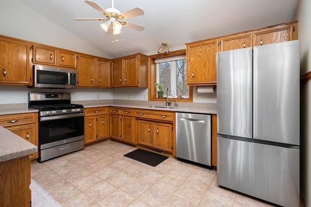1944 Linda Ln, Saint Cloud, MN 56301 - kitchen with stainless steel appliances, lofted ceiling, brown cabinetry, a ceiling fan, and light countertops