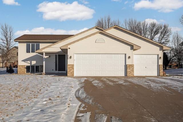 view of front of home with concrete driveway, a garage, and brick siding