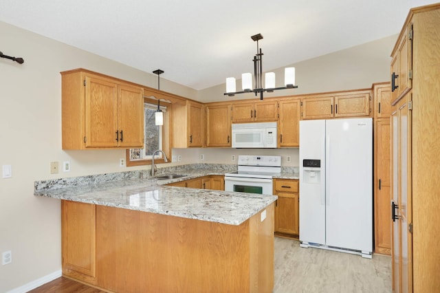 kitchen with a notable chandelier, a sink, light stone counters, white appliances, and a peninsula