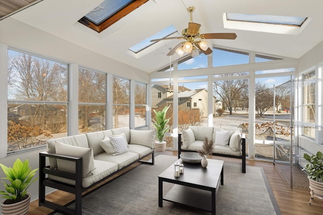 sunroom with lofted ceiling with skylight and ceiling fan