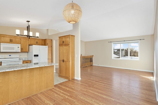 kitchen with white appliances, light wood-style flooring, vaulted ceiling, pendant lighting, and a chandelier