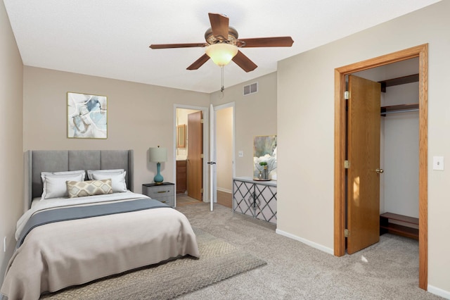 bedroom with a spacious closet, visible vents, baseboards, and carpet