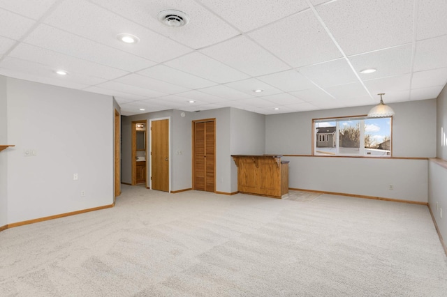spare room featuring baseboards, visible vents, recessed lighting, a paneled ceiling, and light colored carpet
