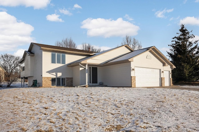 view of front of home with brick siding, concrete driveway, and an attached garage