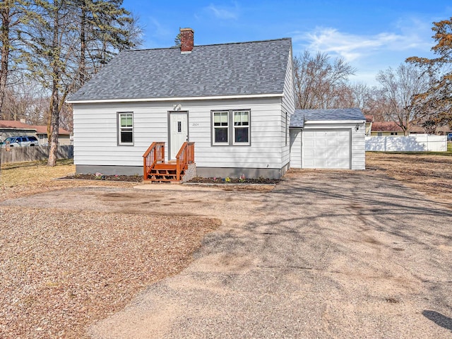 2604 Clearwater Rd, Saint Cloud, MN 56301 - cape cod-style house featuring a shingled roof, a garage, a chimney, and asphalt driveway