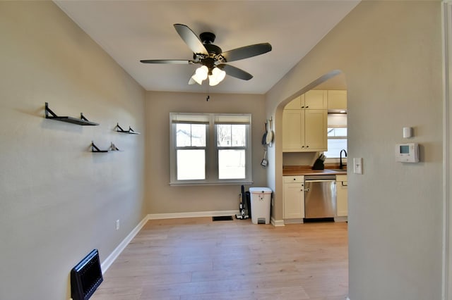 2604 Clearwater Rd, Saint Cloud, MN 56301 - kitchen with dishwasher, a sink, ceiling fan, light wood-style flooring, and arched walkways