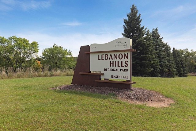 community / neighborhood sign with a lawn
