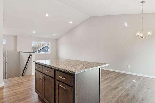 224 9th Ave Ct NW, Lonsdale, MN 55046 - kitchen featuring lofted ceiling, light countertops, light wood-style floors, a notable chandelier, and a center island