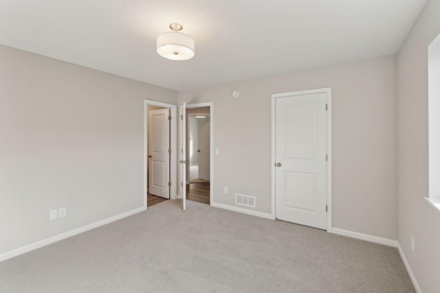224 9th Ave Ct NW, Lonsdale, MN 55046 - unfurnished bedroom with visible vents, baseboards, and light colored carpet