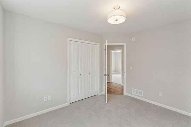 224 9th Ave Ct NW, Lonsdale, MN 55046 - unfurnished bedroom with carpet flooring, baseboards, visible vents, and a closet