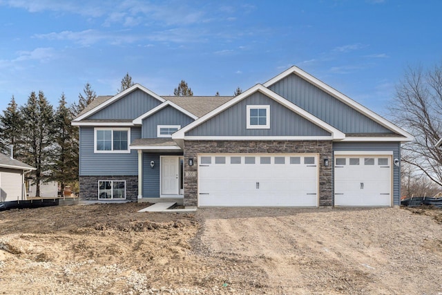 224 9th Ave Ct NW, Lonsdale, MN 55046 - view of front of home with an attached garage, board and batten siding, a shingled roof, stone siding, and driveway